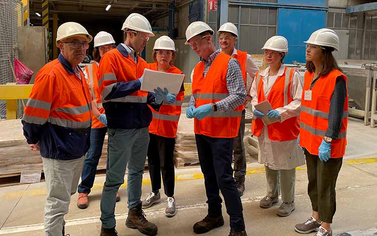 Group in hard hats and high viz helments working together